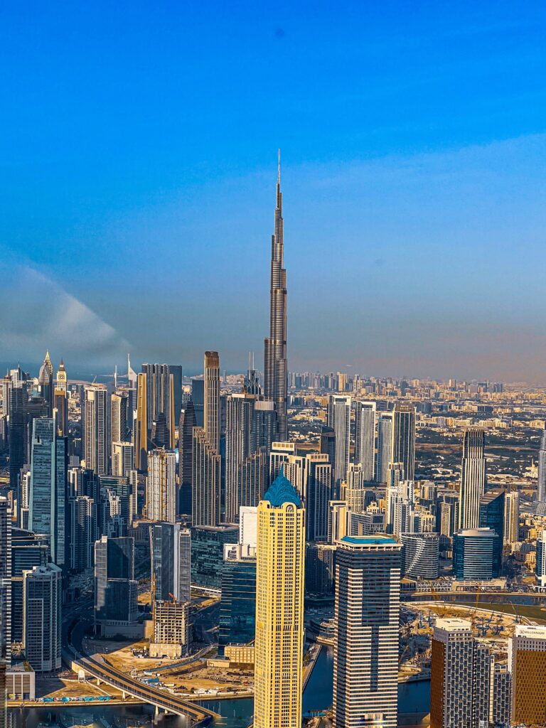 Helicopter flying above Burj Khalifa with a clear view of Downtown Dubai and city lights
